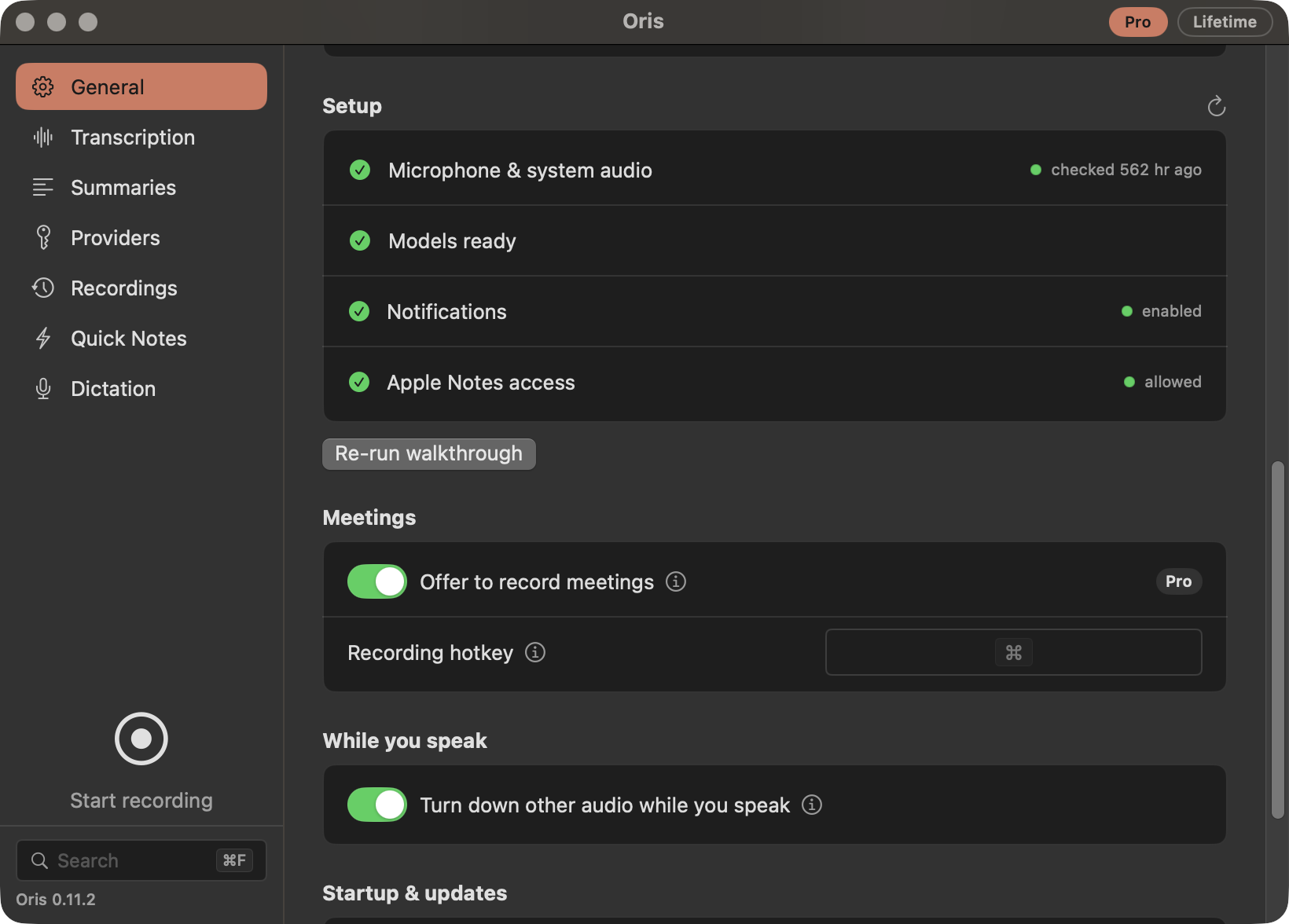 The Oris settings window in dark mode: a seven-row left rail (General, Transcription, Summaries, Providers, Recordings, Quick Notes, Dictation) with General selected and filled in ember, beside grouped boxes for Setup (green checks for Microphone & system audio, Models ready, Notifications and Apple Notes access), Meetings (an 'Offer to record meetings' switch turned on, carrying a Pro chip, and a Recording hotkey field) and While you speak (a 'Turn down other audio while you speak' switch turned on). Below the rail's seven rows, a round record button labelled 'Start recording' sits above a search field with a ⌘F cap and the version line, 'Oris 0.11.2'.